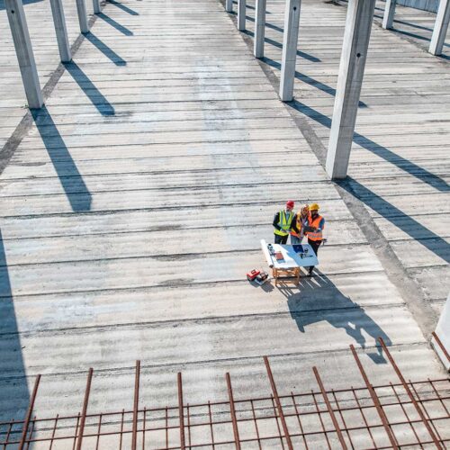 aerial view of building construction and workers