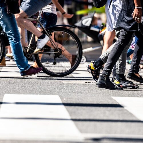 crosswalk with people walking and biking