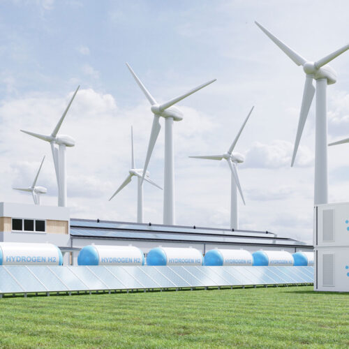 hydrogen storage tanks with wind turbines in background
